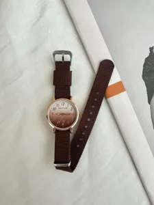 Casual canvas strap quartz watch with gradient dial, minimalist student fashion timepiece.