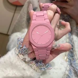 Close-up detail of a minimalist pink quartz watch with octagonal bezel and sleek matte strap.