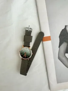 Minimalist green gradient dial quartz watch with durable canvas strap for casual daily wear.