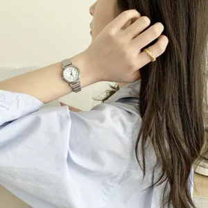 Minimalist women's quartz watch detail shot, elegant retro wrist accessory design.