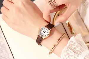 Vintage women small dial quartz watch with elegant brown leather strap for daily wear.
