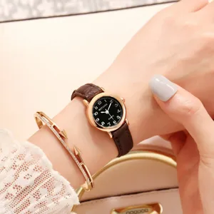 Women vintage small dial quartz watch with brown leather strap, minimalist retro style.