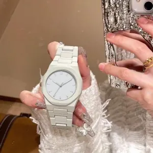 White quartz watch with octagonal bezel and minimalist dial for women and men daily wear.