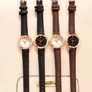 Detailed view of women's quartz watch with slim leather strap and small dial, elegant design.