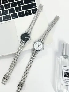Detailed view of minimalist women quartz wristwatches with black and white dials and silver straps.