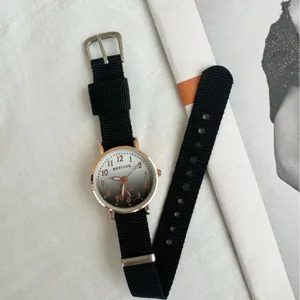 Minimalist quartz watch with black nylon canvas strap and rose gold dial for daily wear.
