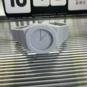 Grey plastic quartz watch with integrated band octagonal bezel minimalist dial closeup detail view