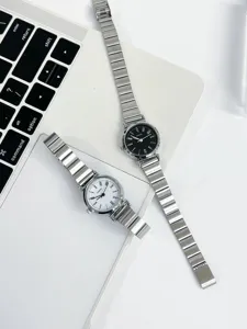 Detailed view of vintage minimalist women quartz watches with silver flex metal straps.