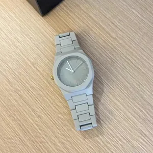 Grey quartz watch detail showing the matte octagonal bezel, sleek dial, and integrated band.