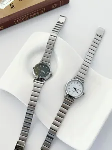 Minimalist women quartz watch with slim metal strap and classic round dial fashion accessory.