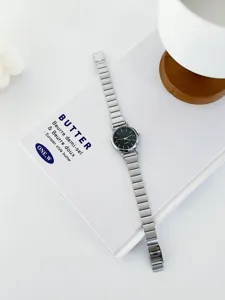 Minimalist women quartz watch detail, elegant black dial and slim metal strap for daily wear.