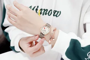 Close-up of a stylish women's nylon strap quartz watch with minimalist dial and bracelet.