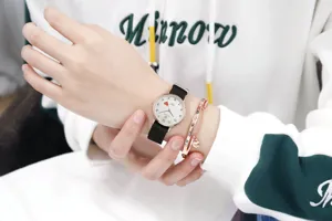 Minimalist quartz watch with black nylon strap and cute red heart dial detail for women.