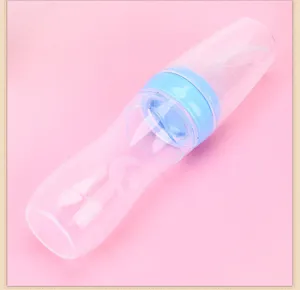 Silicone baby squeeze feeding bottle detail view showing graduation scale and blue cap design.