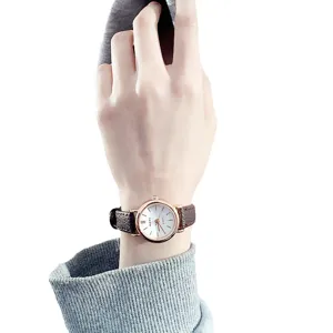 Minimalist women's quartz watch with brown leather strap and rose gold bezel, casual chic style.
