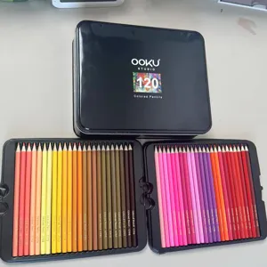 Detailed view of 120 colored pencils set in black metal tin box with vibrant color range.