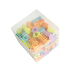 Detailed view of colorful plastic pencil sharpeners in a clear box, school stationery supply.