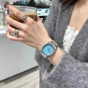 Minimalist square quartz watch for women with light blue dial and solid steel strap.