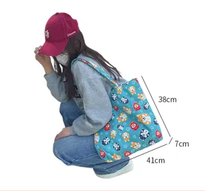 Detail view of blue canvas tote bag featuring cute Shiba Inu print and handy dimension layout.