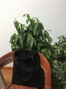 Bolso tote clásico de lona negra para mujer, bolsa de compras de hombro casual, color liso.