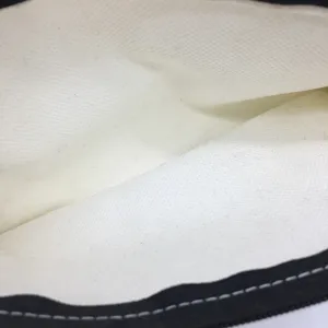 Detail view of the durable canvas pencil case interior lining, featuring neat white stitching.