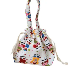 Cute canvas drawstring handbag with cartoon print, casual tote bag for daily commuting and storage.