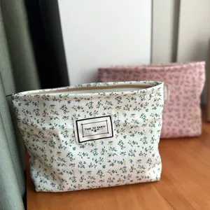 Canvas floral cosmetic bag, portable travel makeup storage pouch with zipper closure.