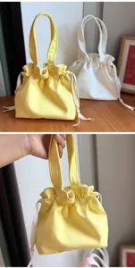 Detailed view of the cute canvas drawstring lunch bag, featuring portable handles and solid color design.
