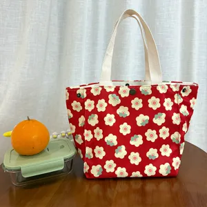 Cute floral canvas lunch bag with double top handles, ideal for school and daily use.