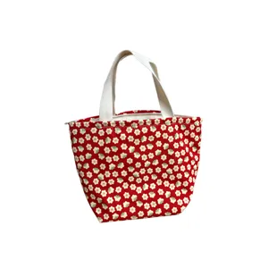 Red canvas lunch tote bag with cute floral print, zipper closure and sturdy fabric handles.