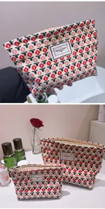 Detail shot of the cute knitted cosmetic pouch featuring a vibrant tulip floral pattern.
