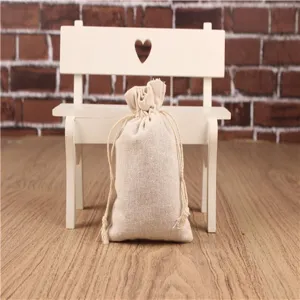 Detailansicht eines schlichten Baumwoll-Leinen Kordelzugsacks auf einem Holztisch.