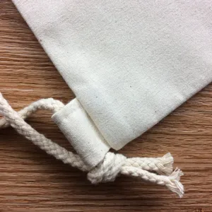 Close up detail of blank canvas drawstring bag texture, plain cotton fabric and sturdy rope.