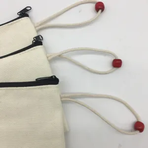 Blank DIY canvas pencil pouch with black zipper and red wooden bead lanyard for office school.