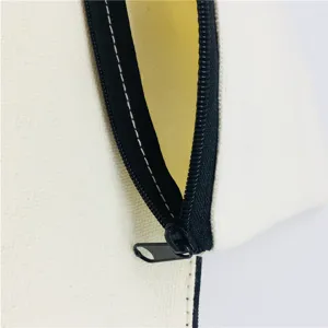 Close-up detail of white canvas zipper pouch, showing black zipper and neat stitching.