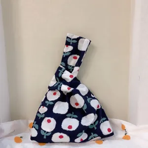 Detail view of the cotton Japanese knot bag with cute floral print and unique handle structure.