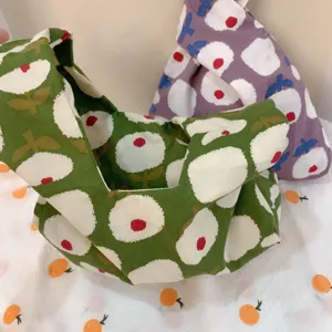Cotton Japanese knot bag close-up view, floral pattern wrist handbag, casual cute daily purse.