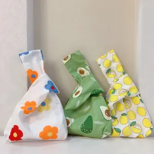Detail des japanischen Knoten Handgelenkbeutels mit Blumen Avocado und Zitronenmuster Baumwolltasche.