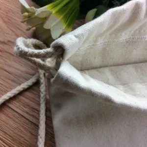 Canvas drawstring bag detail showing thick cotton cord and durable fabric texture close up.