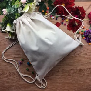 Detail shot of blank white canvas drawstring backpack displayed with floral background.