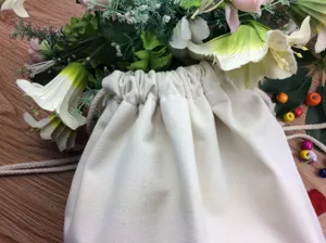 Plain white canvas drawstring bag for DIY hand painting, eco-friendly shopping gift pouch.