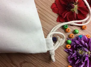 Close-up detail of blank canvas drawstring bag, perfect for DIY painting and crafts gift.