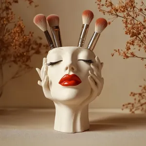 Detail view of the unique face shaped makeup brush holder, aesthetic boho desktop organizer.