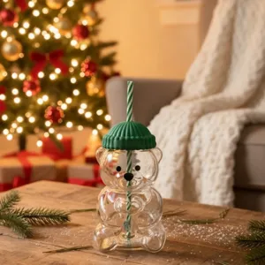 Cute bear glass straw cup with green hat lid and striped straw for drinks, detail view