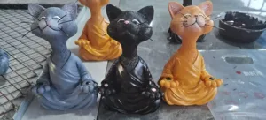 Resin meditation cat figurine detail shot, cute zen animal desktop decor for home and garden.
