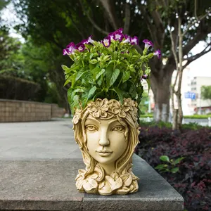 Resin goddess flower pot detail with exquisite facial carving and succulent arrangement outdoor garden.
