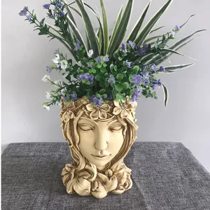 Resin goddess face flower pot with artificial plants, creative home decor planter.