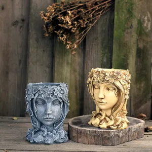 Close-up view of creative resin goddess head succulent planter in vintage rustic setting.