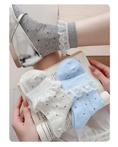 Detail shot of women sweet lace ruffle socks, breathable mesh polka dot cotton short socks.