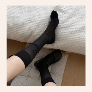 Black mesh split-toe crew socks detail view, breathable summer hosiery for women.